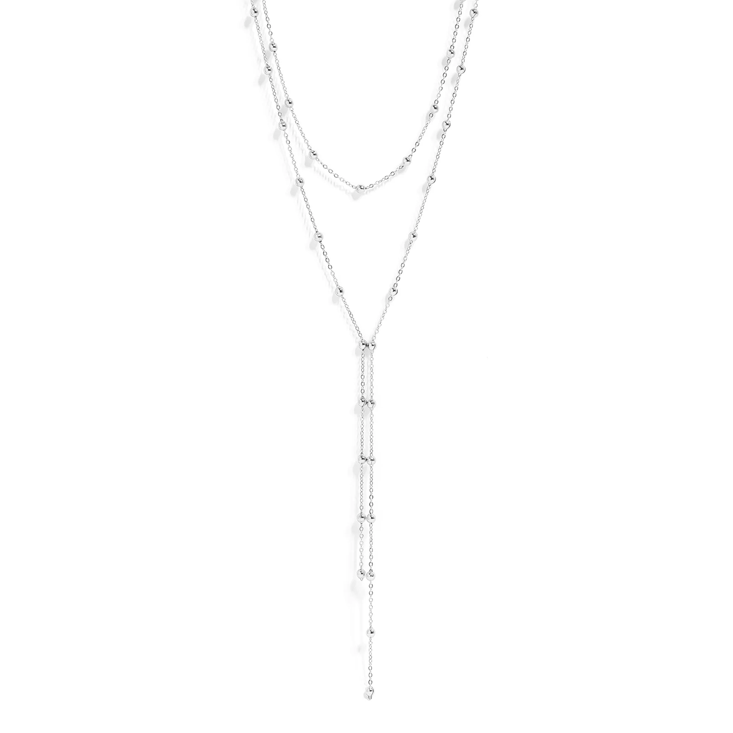 Layered silver necklaces on a white background