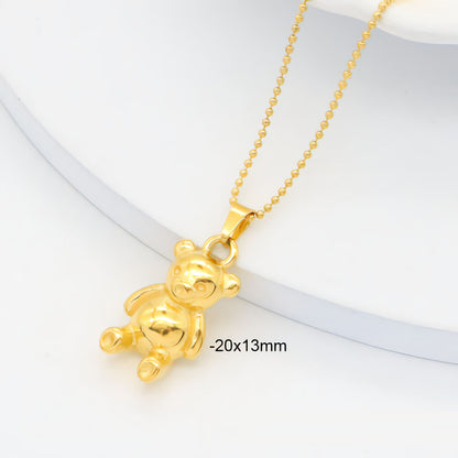 Gold teddy bear pendant on a chain with dimensions displayed