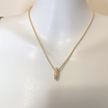 Gold necklace with a pendant on a mannequin