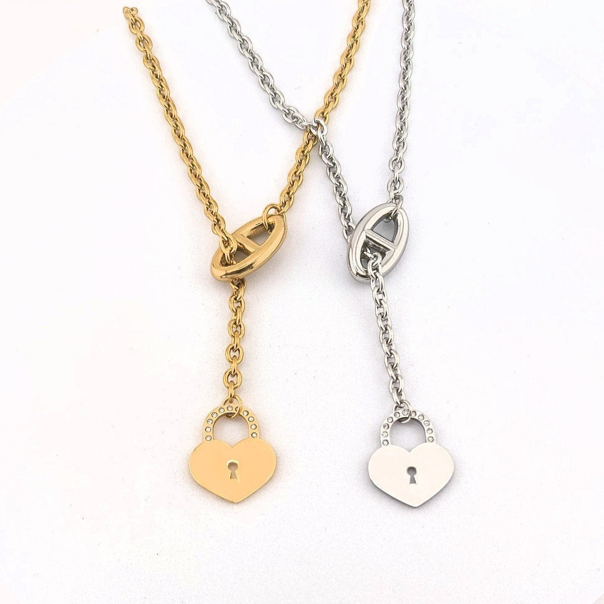 This Stainless Steel chain necklace features a distinctive toggle closure and a heart-shaped padlock pendant