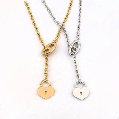 This Stainless Steel chain necklace features a distinctive toggle closure and a heart-shaped padlock pendant