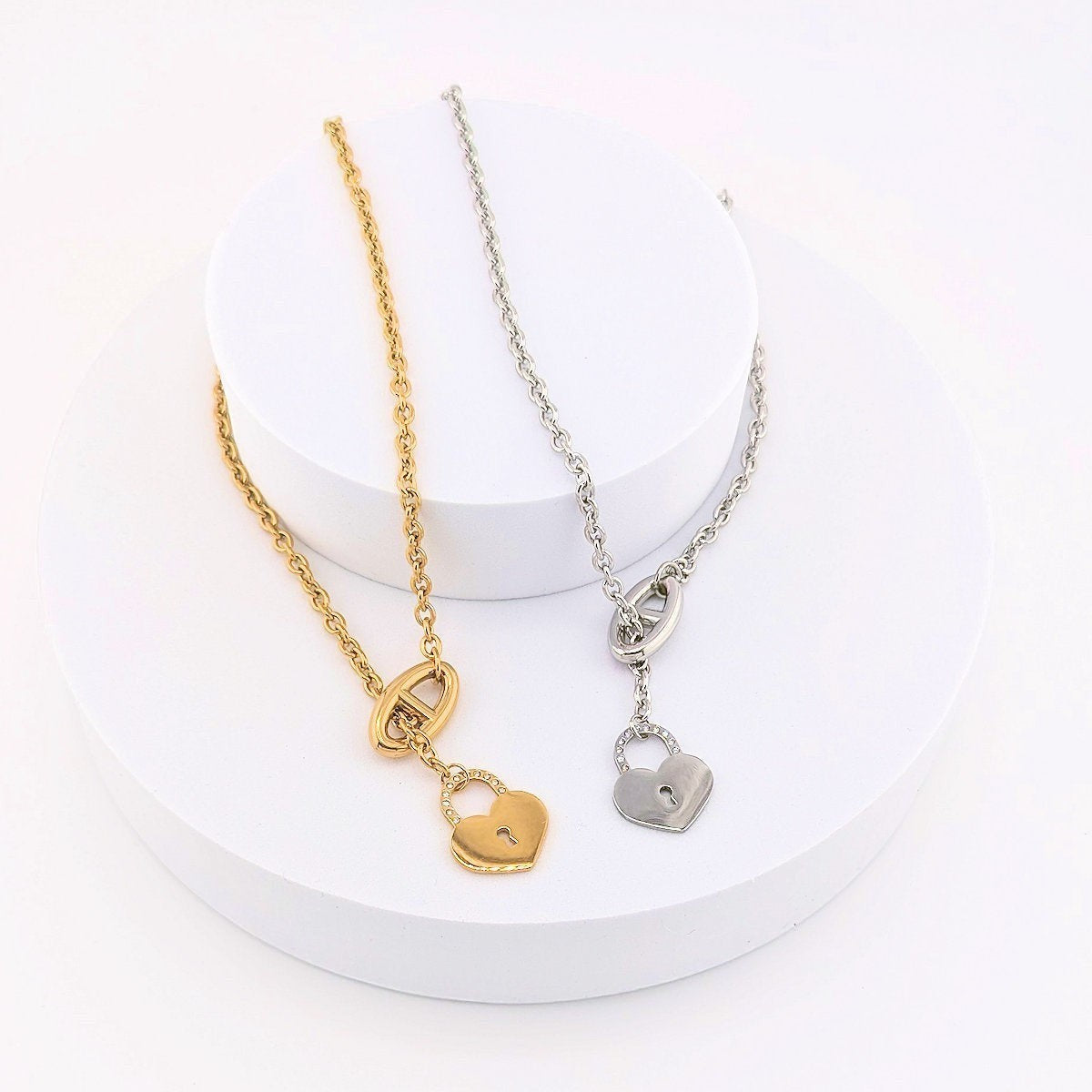 This Stainless Steel chain necklace features a distinctive toggle closure and a heart-shaped padlock pendant