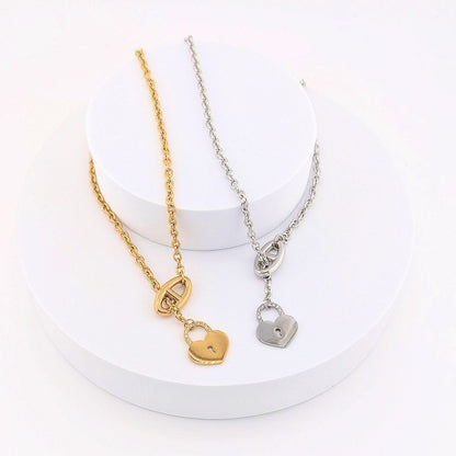This Stainless Steel chain necklace features a distinctive toggle closure and a heart-shaped padlock pendant