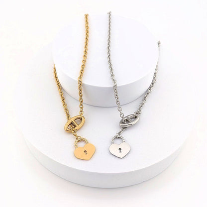 This Stainless Steel chain necklace features a distinctive toggle closure and a heart-shaped padlock pendant
