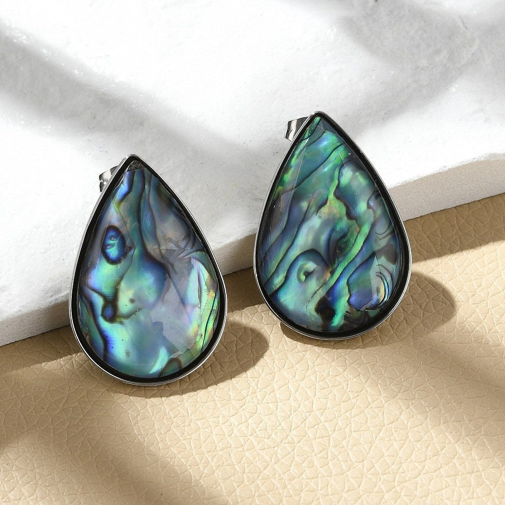 Ninky Designs Australia teardrop stud earrings featuring iridescent blue and green shell inlay in stainless steel.
