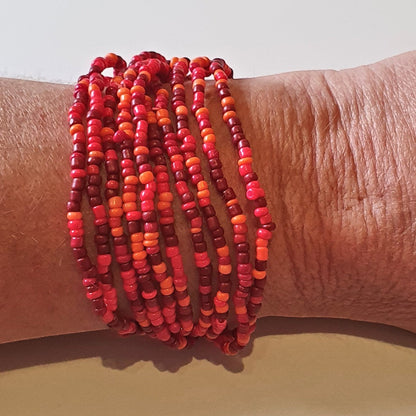 Ninky Designs Australia stretch seed bead bracelets in shades of red worn on a wrist as a stackable set